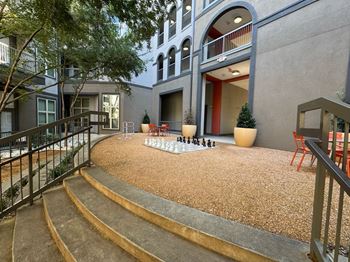 Courtyard with a chess board and chairs at Civic at Frisco Square Apartments, Texas